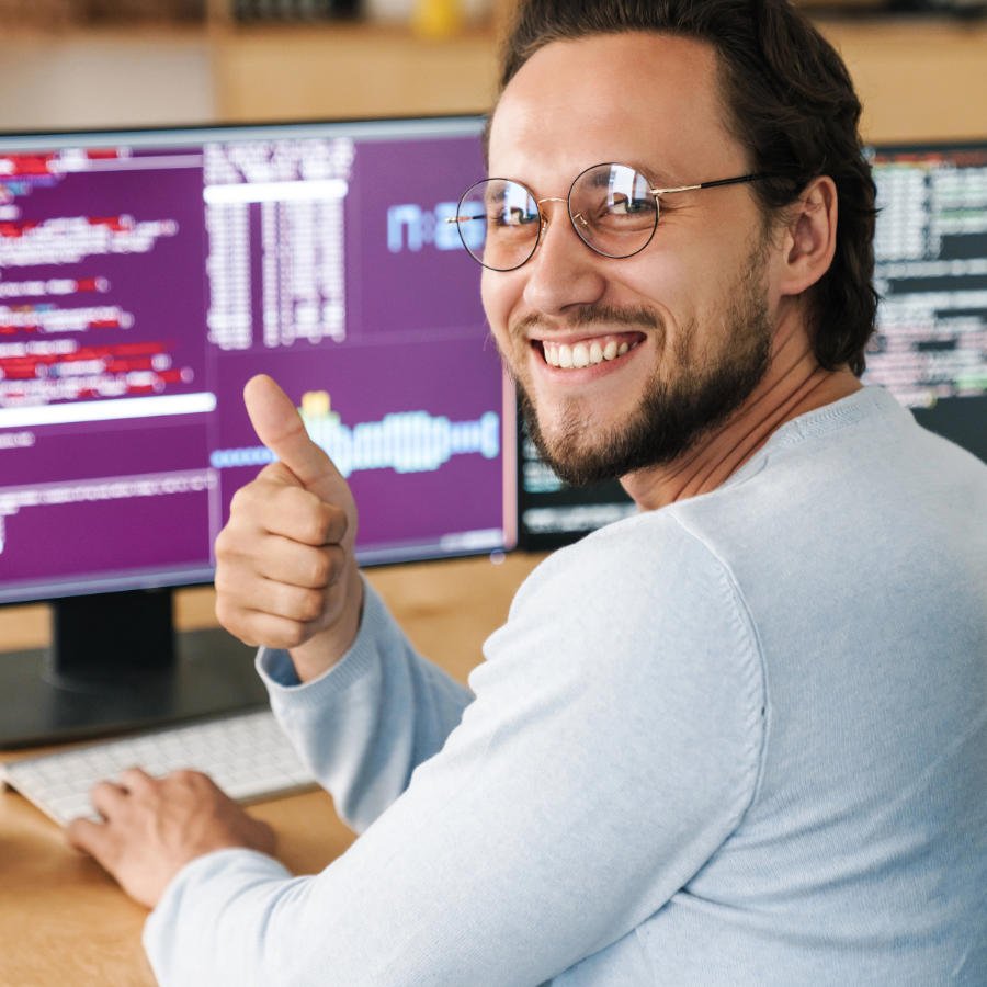 Photo of a software developer working at computer developing software