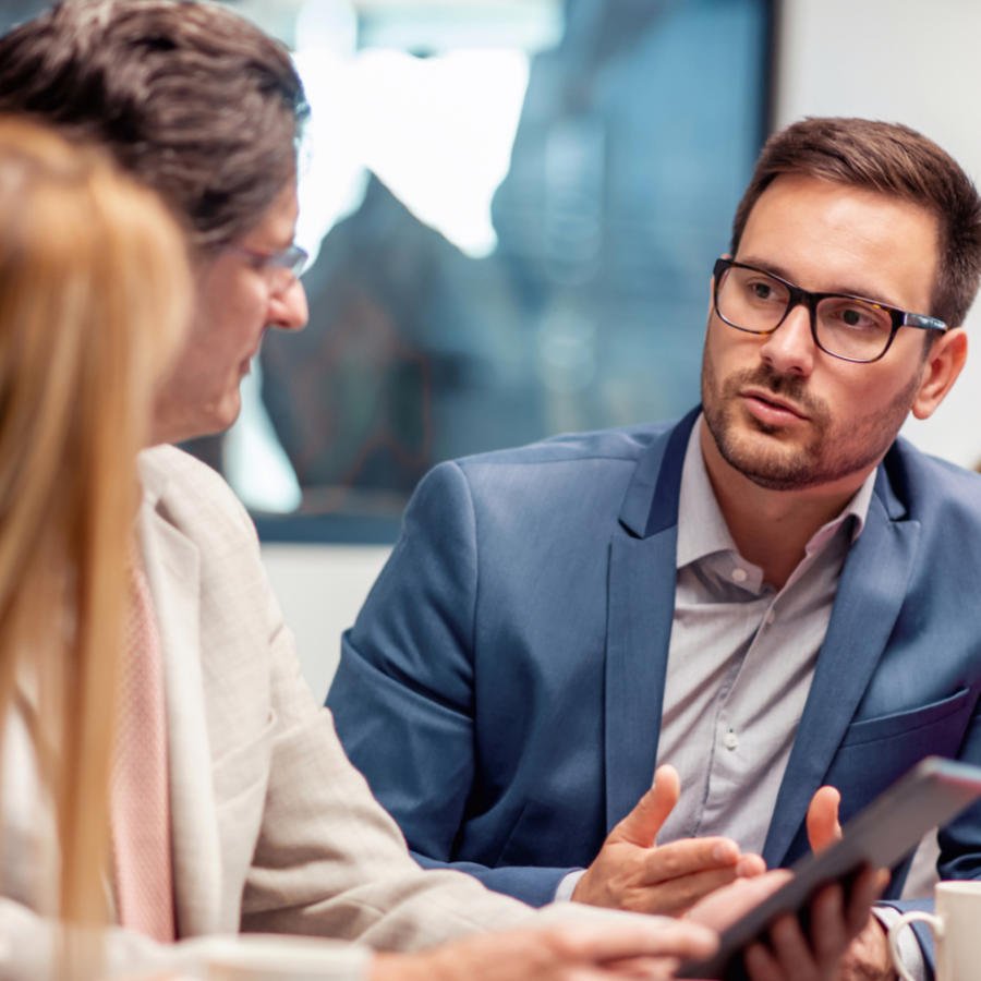 Technology lawyer in meeting discussing matter with clients.